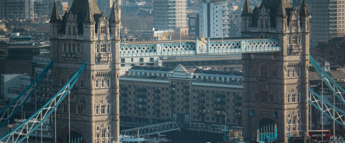 Aerial view of Tower Bridge with London's skyline in the background, capturing urban architecture.
